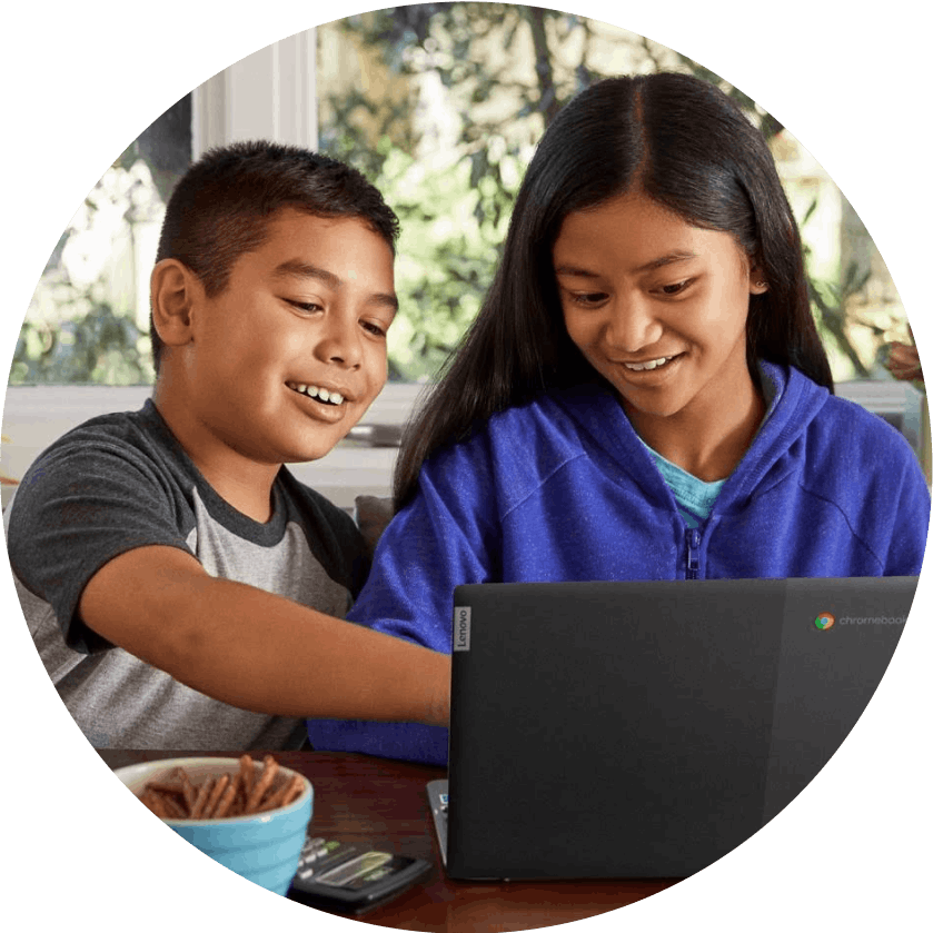 Two children using a chromebook.